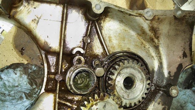 the cover side of the RH crankcase. I am thinking I need to apply grease in the area it has different color grease/oil and the gears.